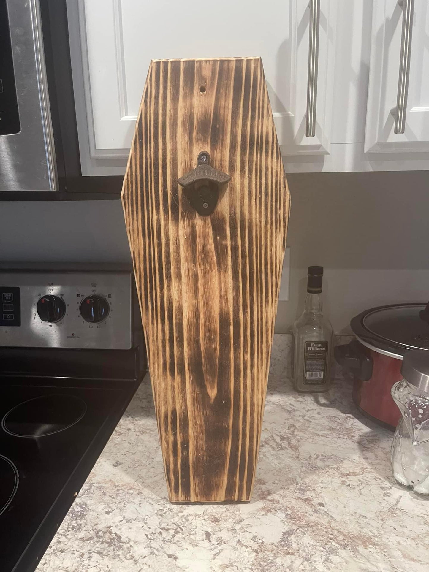 Coffin shaped wall mounted bottle opener